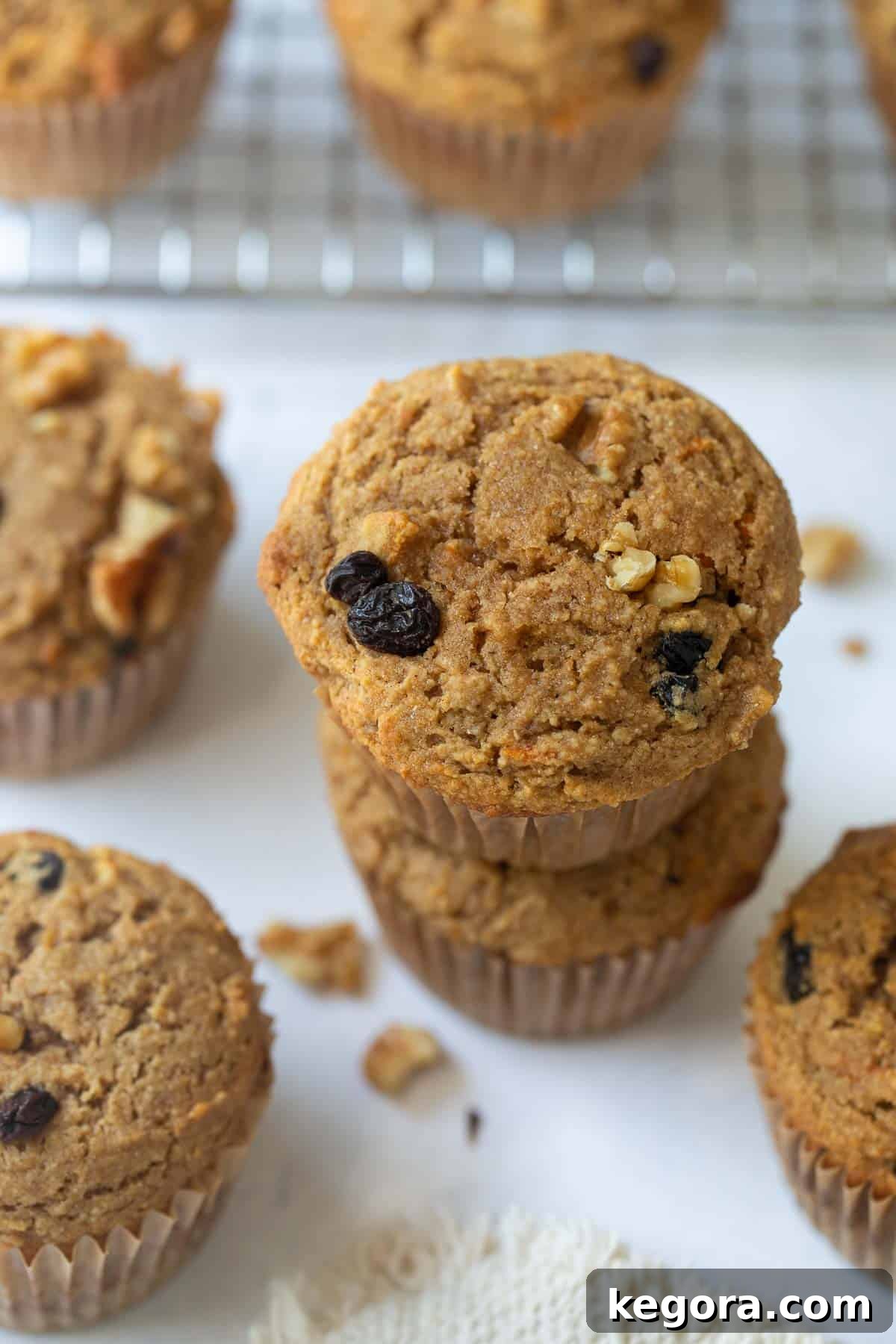 Stacked healthy buckwheat muffins on a wire rack with a white marble background, ready for breakfast or a snack