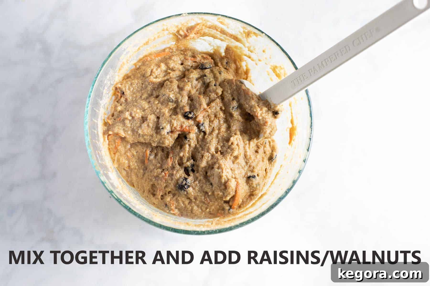 Glass bowl of mixed buckwheat muffin batter ready to be scooped