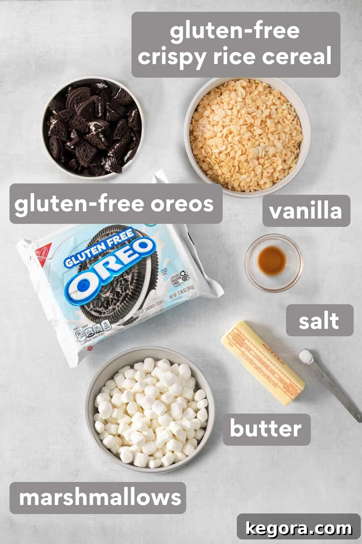 Gluten-Free Oreo Crunch Bars 3 A selection of ingredients for Oreo crispy treats laid out on a clean countertop, including cereal, Oreos, butter, and marshmallows