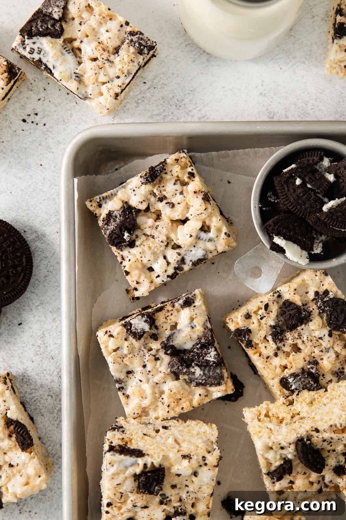 Gluten-Free Oreo Crunch Bars 7 Beautifully cut gluten-free Oreo rice crispy treats arranged on a baking sheet, garnished with extra Oreo crumbles