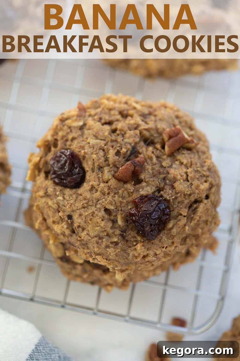 A close-up shot of a single banana breakfast cookie on a cooling rack, showcasing its texture and delicious appeal.