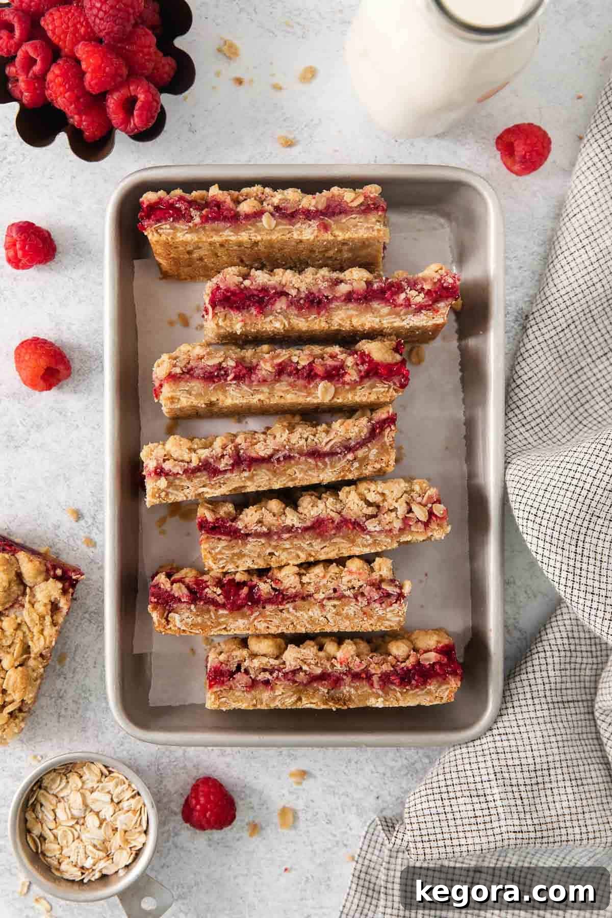Flourless Raspberry Streusel Squares 3 Gluten-free raspberry bars stacked in a baking dish