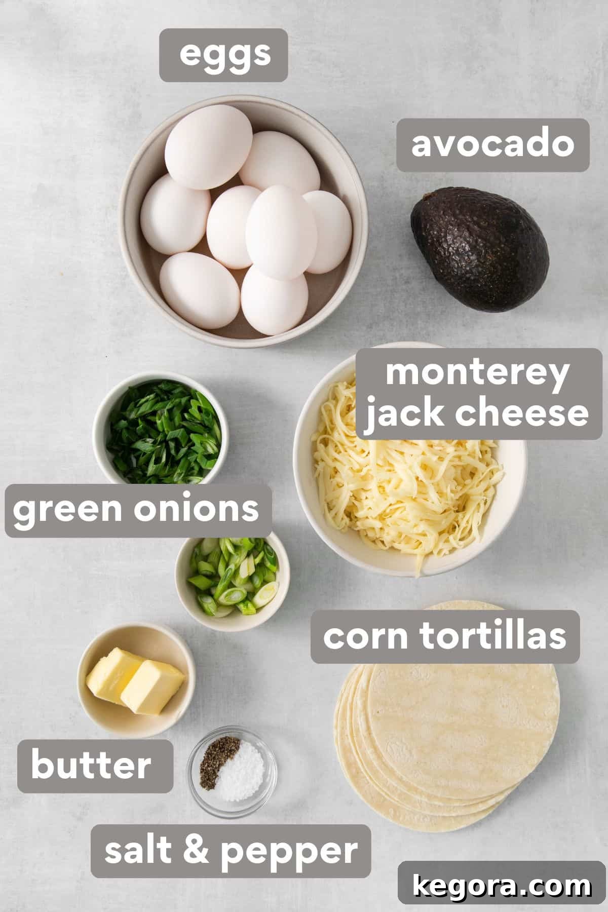 A curated selection of fresh breakfast taco ingredients neatly arranged on a rustic countertop, ready for preparation.