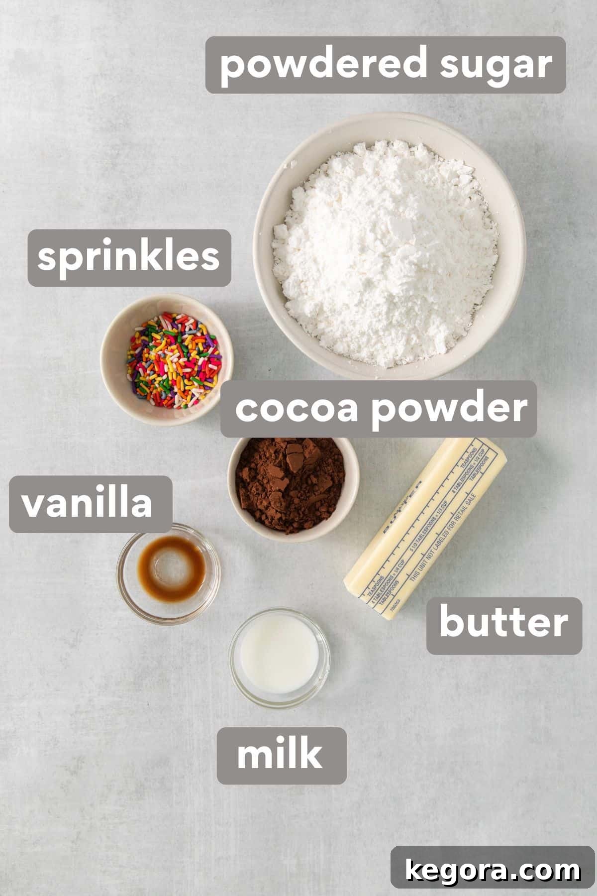 Irresistible Gluten-Free Cookie Cake 4 A simple yet elegant arrangement of cookie cake frosting ingredients on a kitchen countertop, highlighting cocoa powder, butter, and powdered sugar.