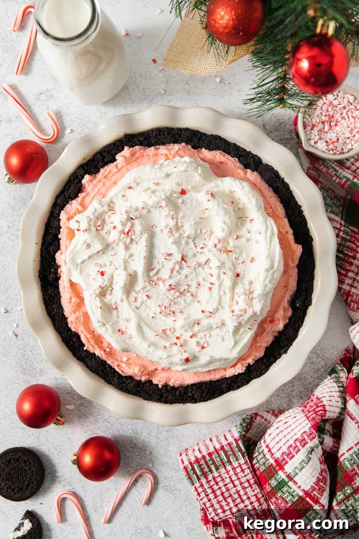 Gluten-Free Minty Oreo Delight 2 An overhead view of a vibrant gluten-free peppermint Oreo pie in a pie dish, garnished with crushed candy canes, ready for the holidays.