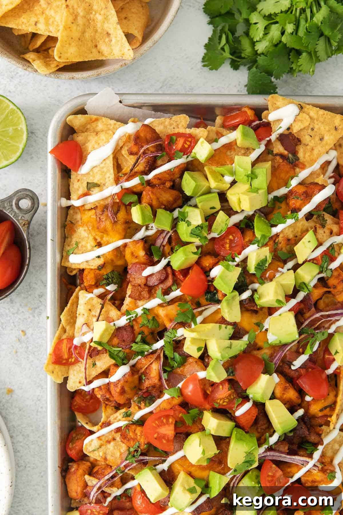 Ultimate BBQ Chicken Nachos 10 Another enticing close-up of BBQ chicken nachos, richly topped and ready to be devoured, highlighting the golden cheese and fresh garnishes.
