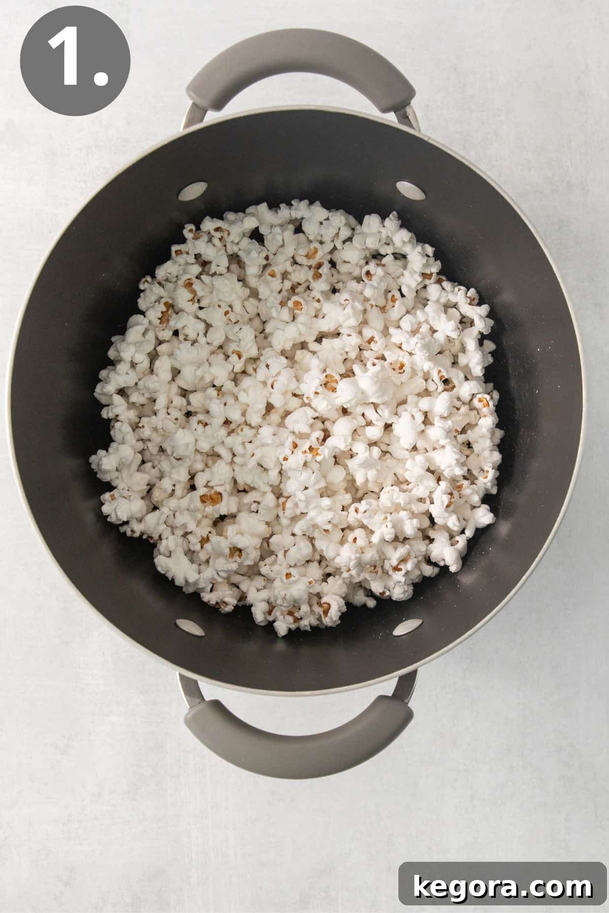 SnickerPop Crunch 4 A large nonstick pot filled with freshly popped white popcorn kernels, indicating the completion of the popping process.