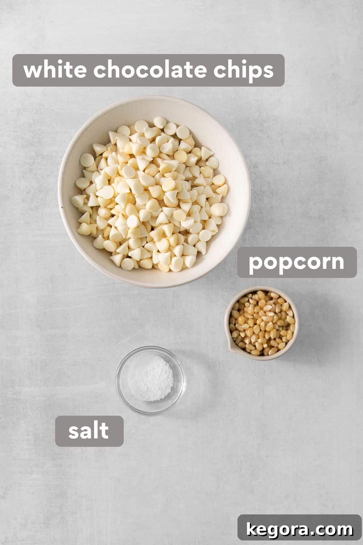 Gourmet White Chocolate Pop 3 Ingredients for white chocolate popcorn laid out on a countertop