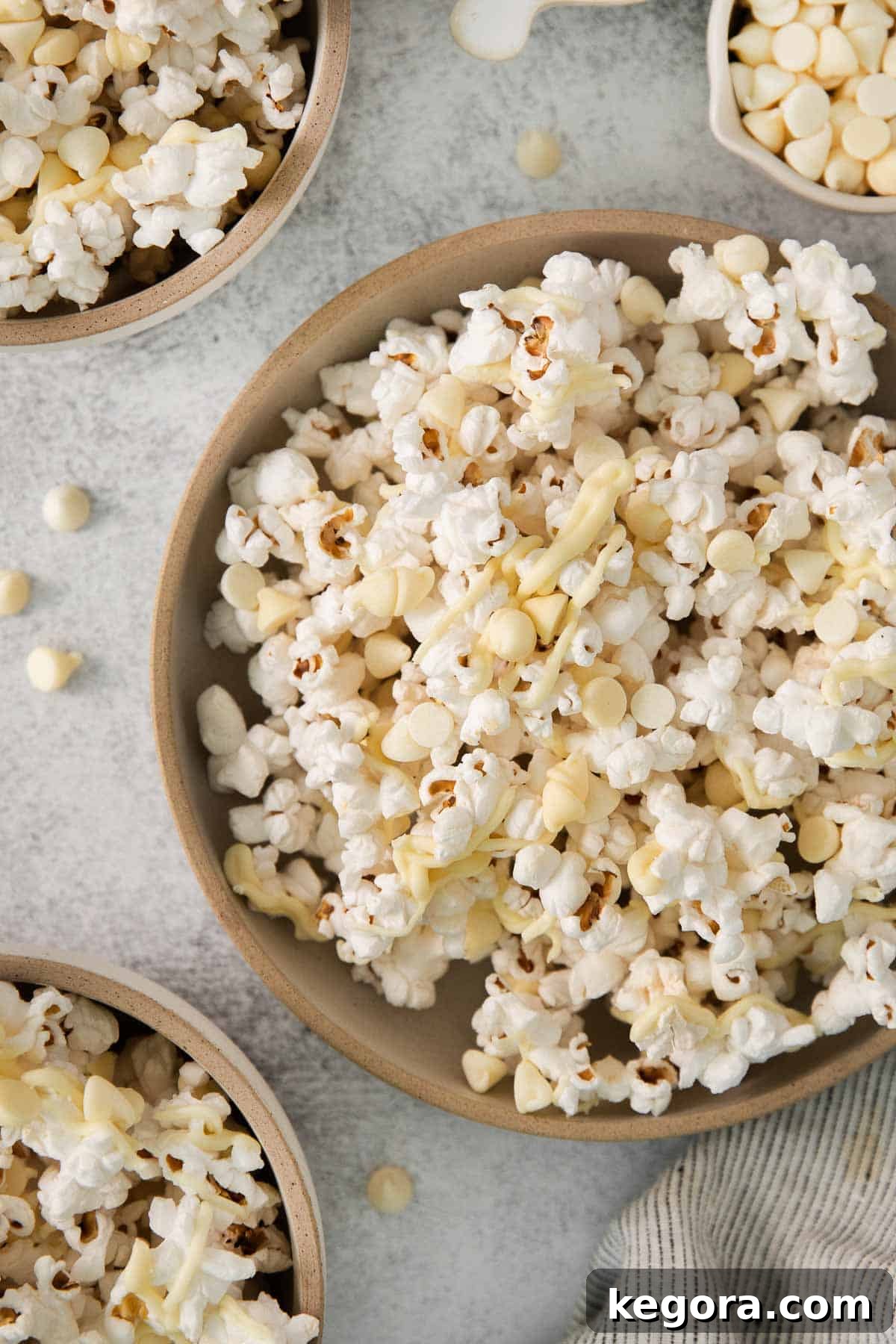 Gourmet White Chocolate Pop 8 Overhead shot of White chocolate popcorn in a bowl with perfectly set chocolate