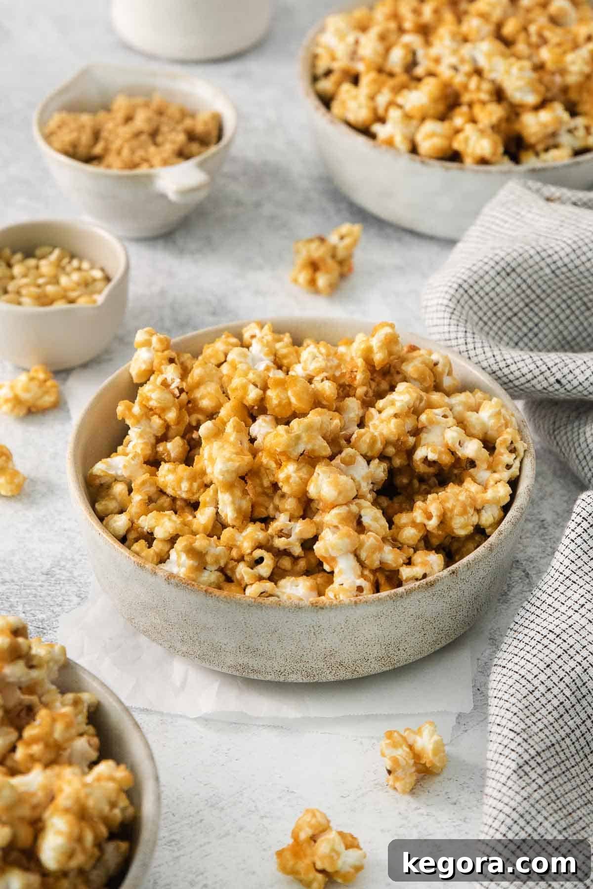 The Gluten-Free Truth About Popcorn 4 Close-up of microwave caramel corn in a clear glass bowl on a kitchen countertop, showcasing its sweet and sticky texture.