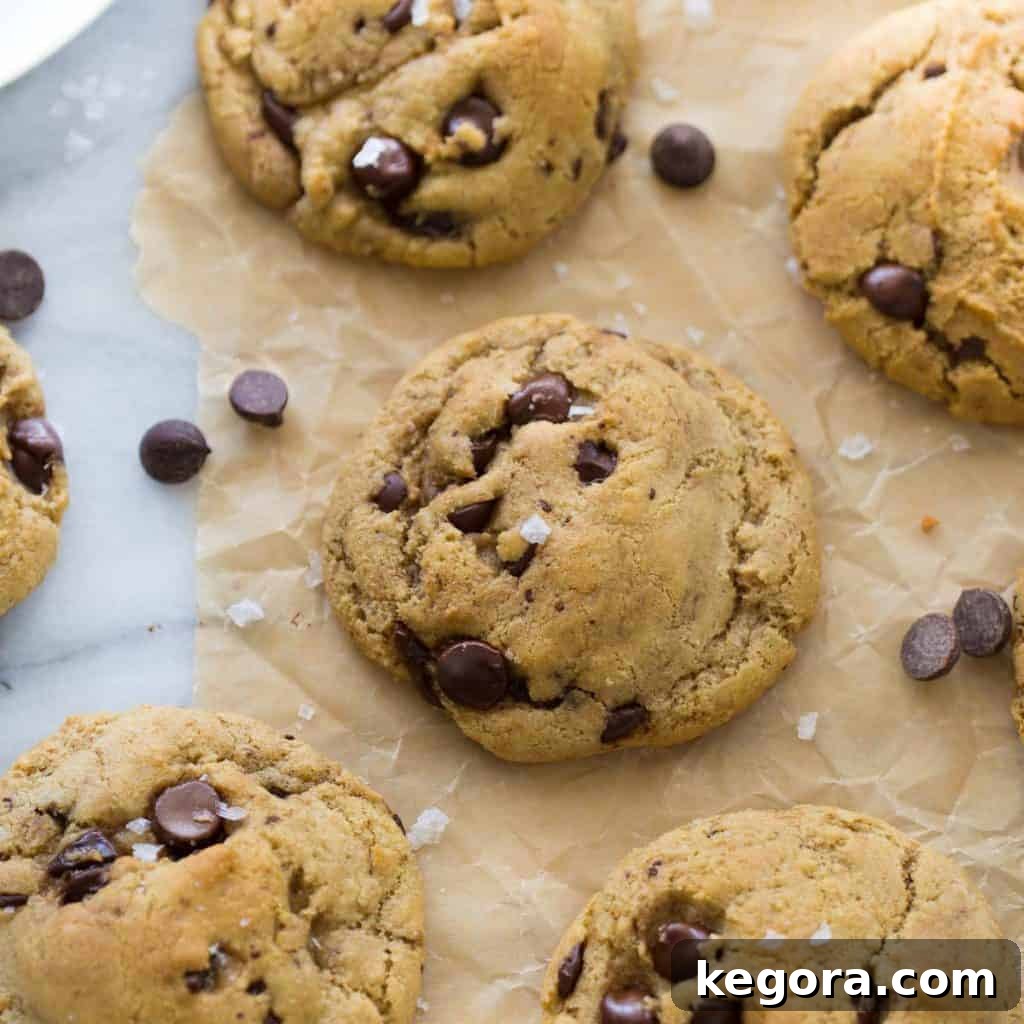 Navigating Gluten-Free Chocolate Chips 3 chocolate chip cookies topped with sea salt on brown parchment paper