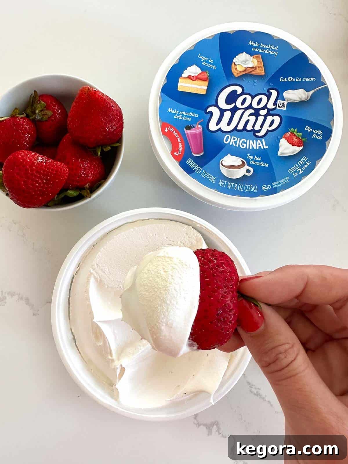 cool whip with strawberry being dipped