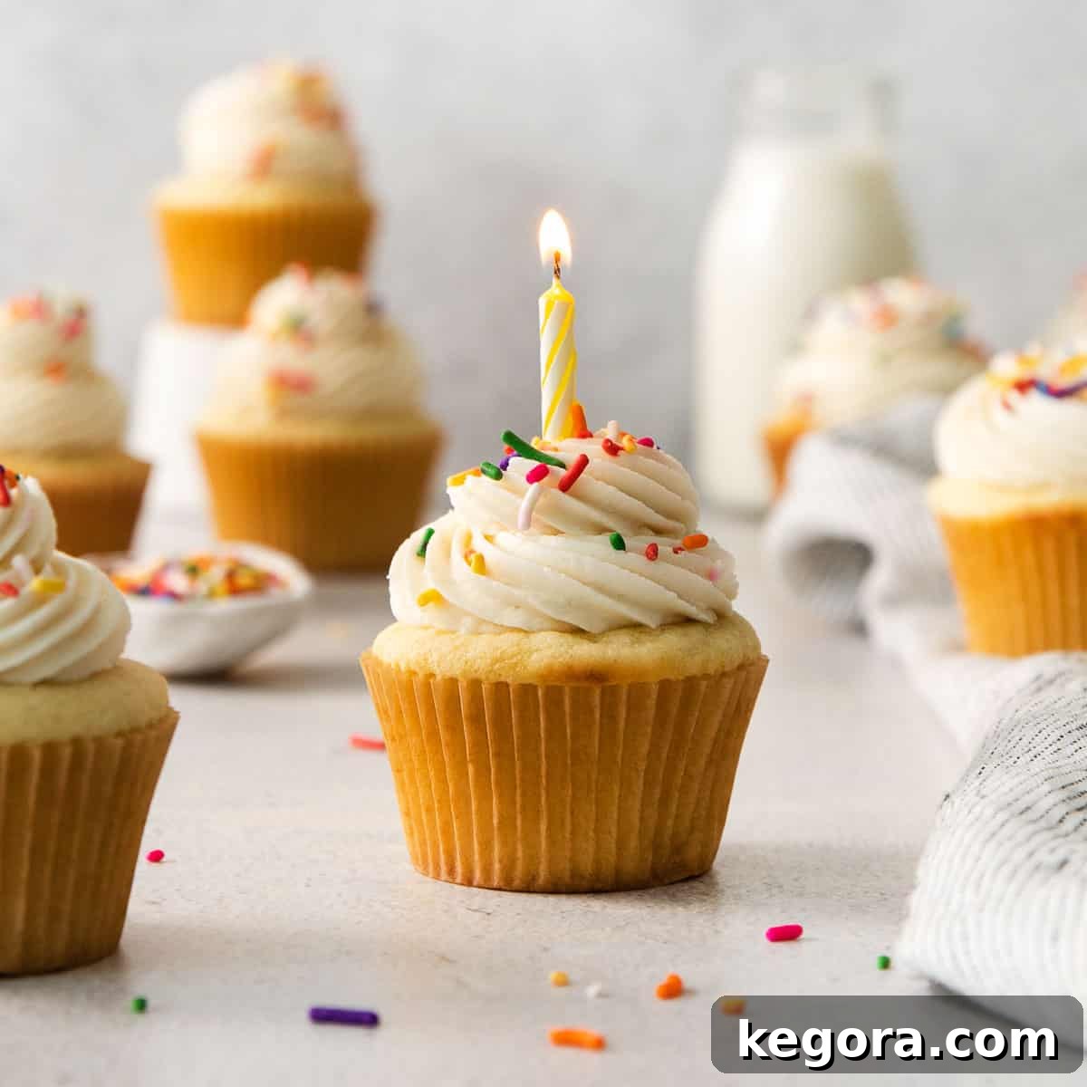 A perfectly baked gluten-free vanilla cupcake adorned with a festive candle, ready for a celebration.
