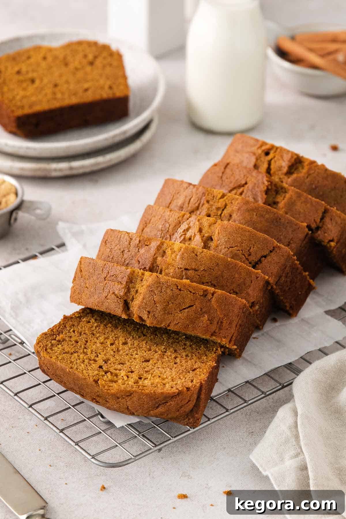 Cozy Gluten-Free Pumpkin Spice Loaf 10 Baked gluten-free pumpkin bread sliced on a wire rack