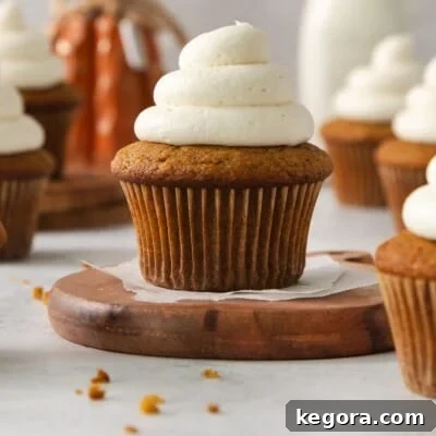 Beautifully frosted gluten-free pumpkin cupcakes on a countertop, inviting to eat.