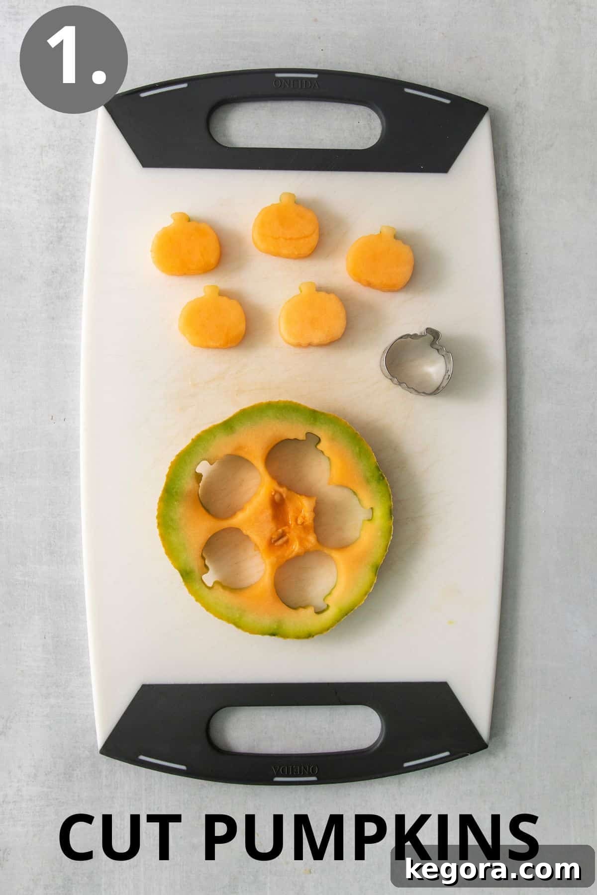 Monster Mash Fruit Salad 4 A slice of cantaloupe on a cutting board with a mini pumpkin cookie cutter pressed into it, ready to create a pumpkin shape.