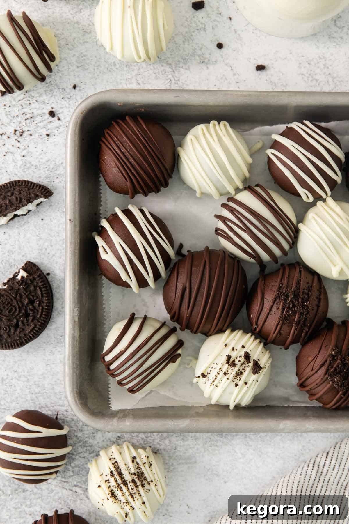 Gluten-Free Oreo Dream Bites 2 An overhead view of gluten-free Oreo truffles on a baking sheet, showcasing their smooth chocolate coating and perfect spherical shape.