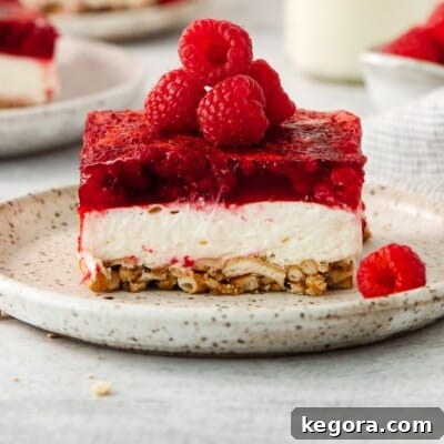 A serving of raspberry pretzel salad on a plate