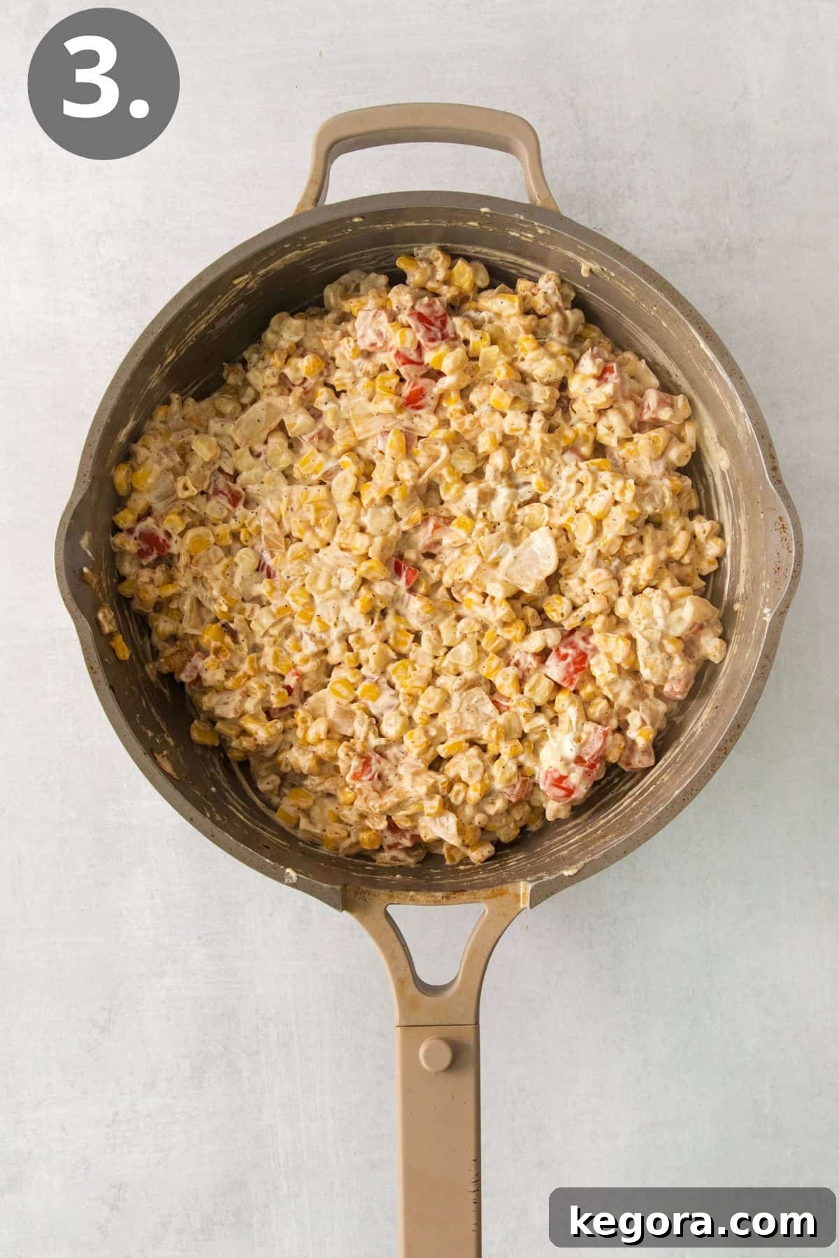 Cream cheese, milk, and seasonings added to the cream cheese corn in a skillet