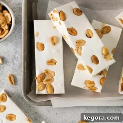 Crafting Irresistible Nougat 10 Homemade Nougat on a baking sheet with parchment paper, perfectly soft and chewy.