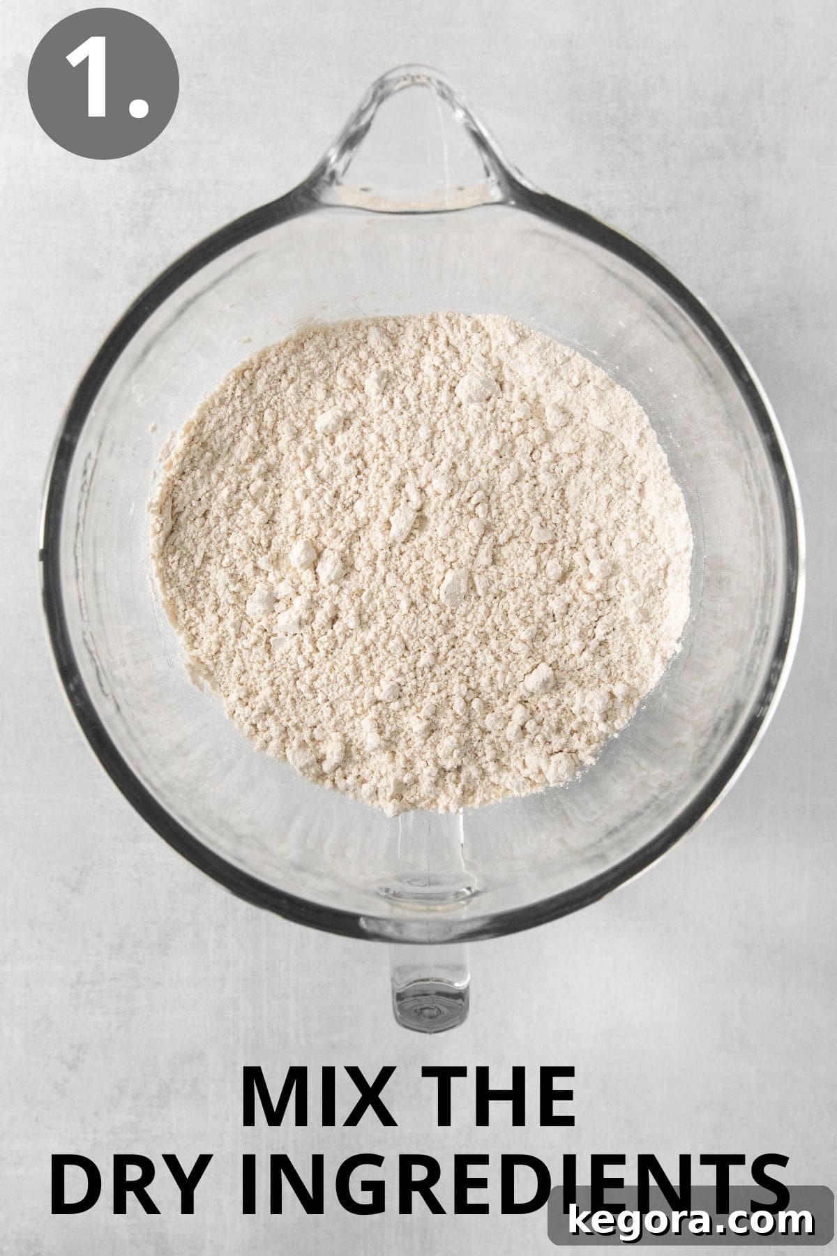 Scrumptious Gluten Free Crescent Rolls 5 Dry ingredients for gluten-free crescent rolls, including flour, sugar, and yeast, in a glass mixing bowl.