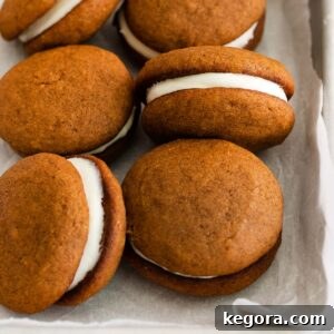 A close up of whoopie pies in a baking dish, highlighting their beautiful orange color and creamy filling.