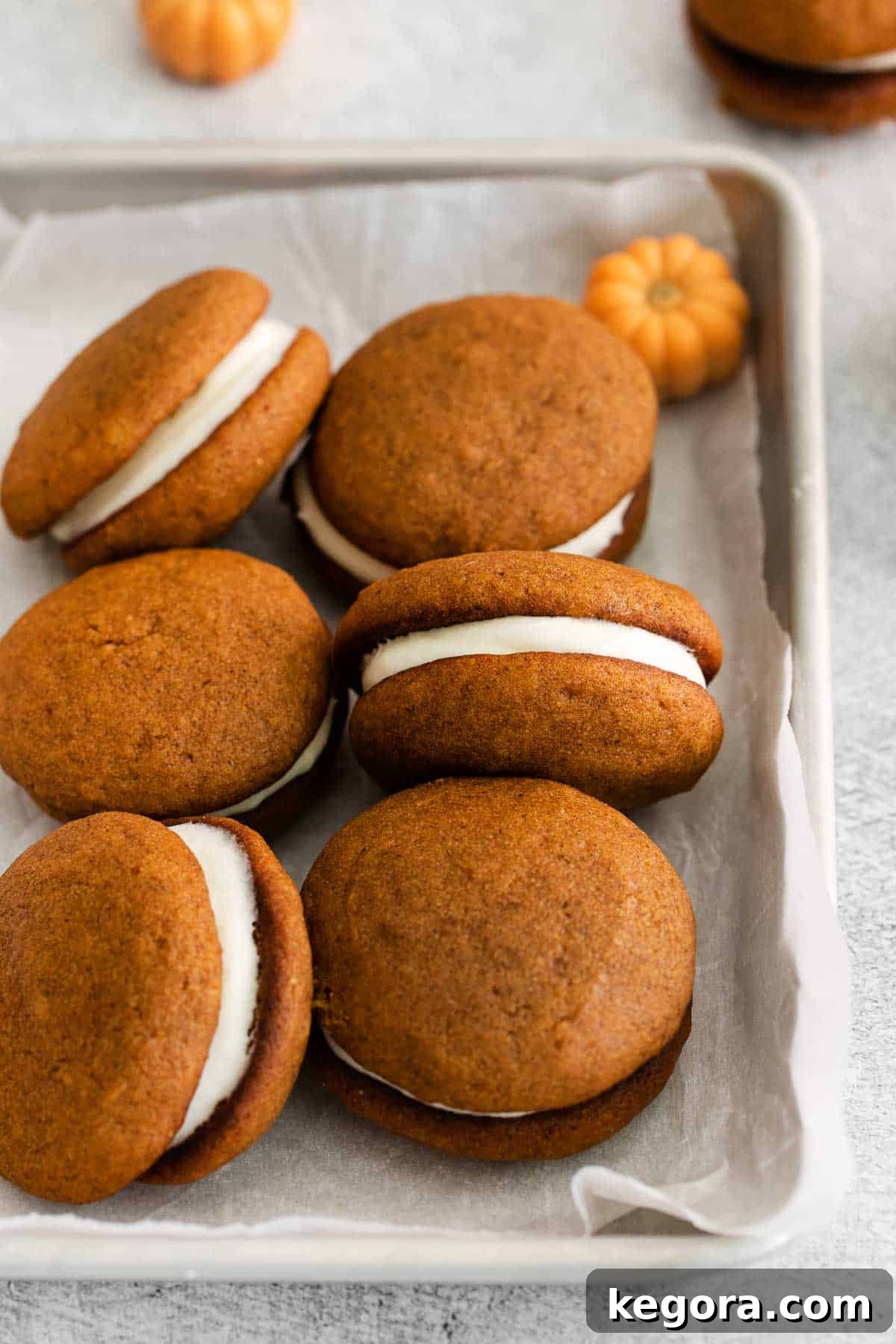 Pumpkin Spice Dreams: Gluten-Free Whoopie Pies 8 Beautifully arranged pumpkin whoopie pies in a baking dish, ready to be served.