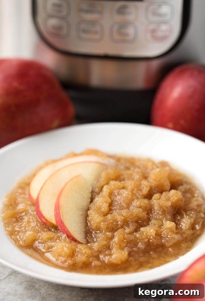 15 Instant Pot Hacks for Effortless Cooking 15 instant pot applesauce in a white bowl with sliced apple with pressure cooker in background