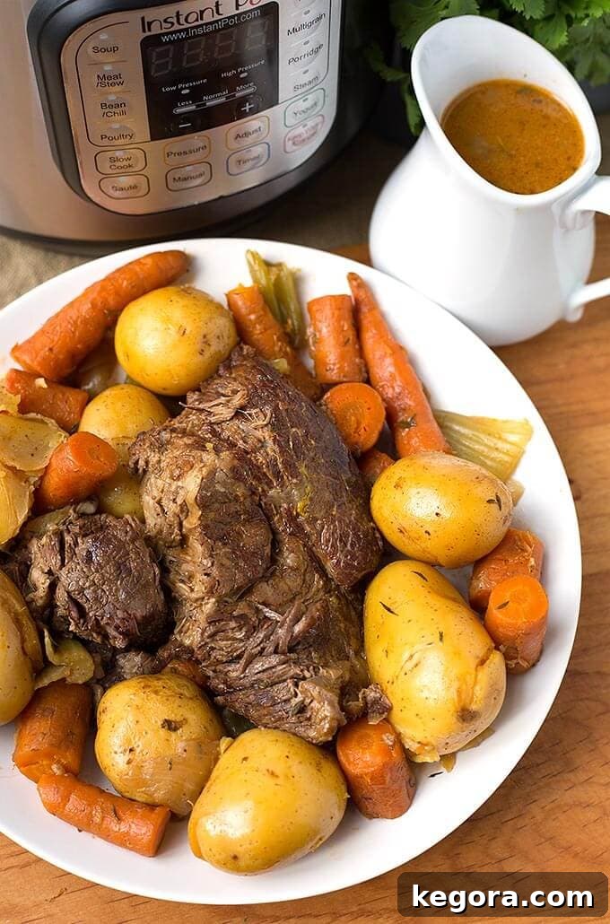 15 Instant Pot Hacks for Effortless Cooking 5 Instant Pot Simple Pot Roast on a white plate with gravy pitcher and pressure cooker in background