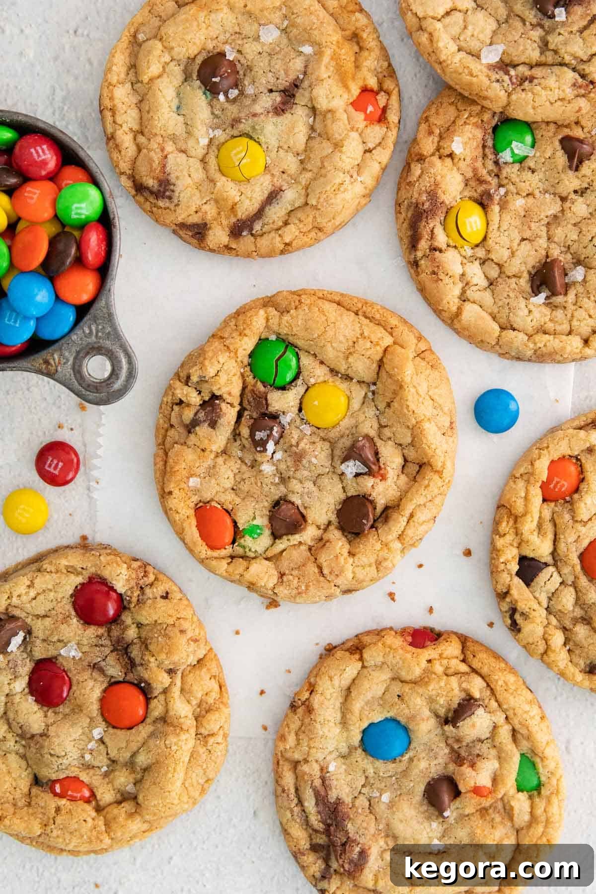Vibrant Gluten-Free M&M Cookie Bliss 10 A pile of vibrant gluten-free M&M cookies featuring classic colors, arranged on a white surface, ready to be enjoyed.
