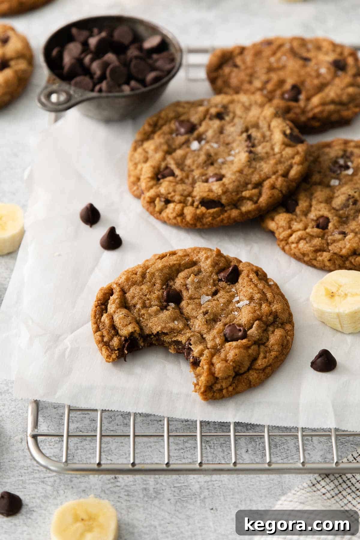 Naturally Sweet Gluten-Free Banana Treats 7 Gluten-free banana cookies cooling on a wire rack, with one cookie having a bite taken out of it