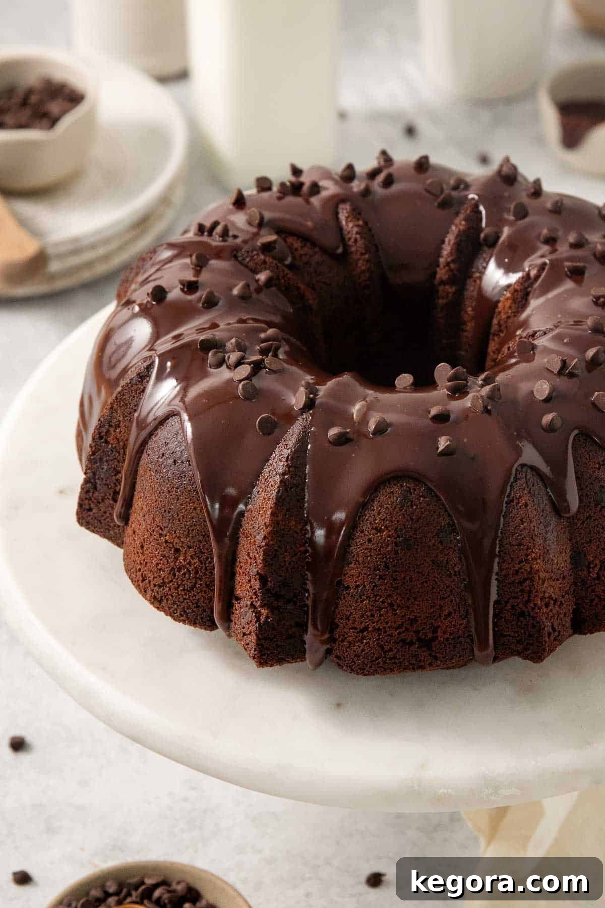 Decadent Gluten-Free Chocolate Bundt 2 gluten-free chocolate bundt cake on a platter, elegantly decorated with chocolate ganache and mini chocolate chips