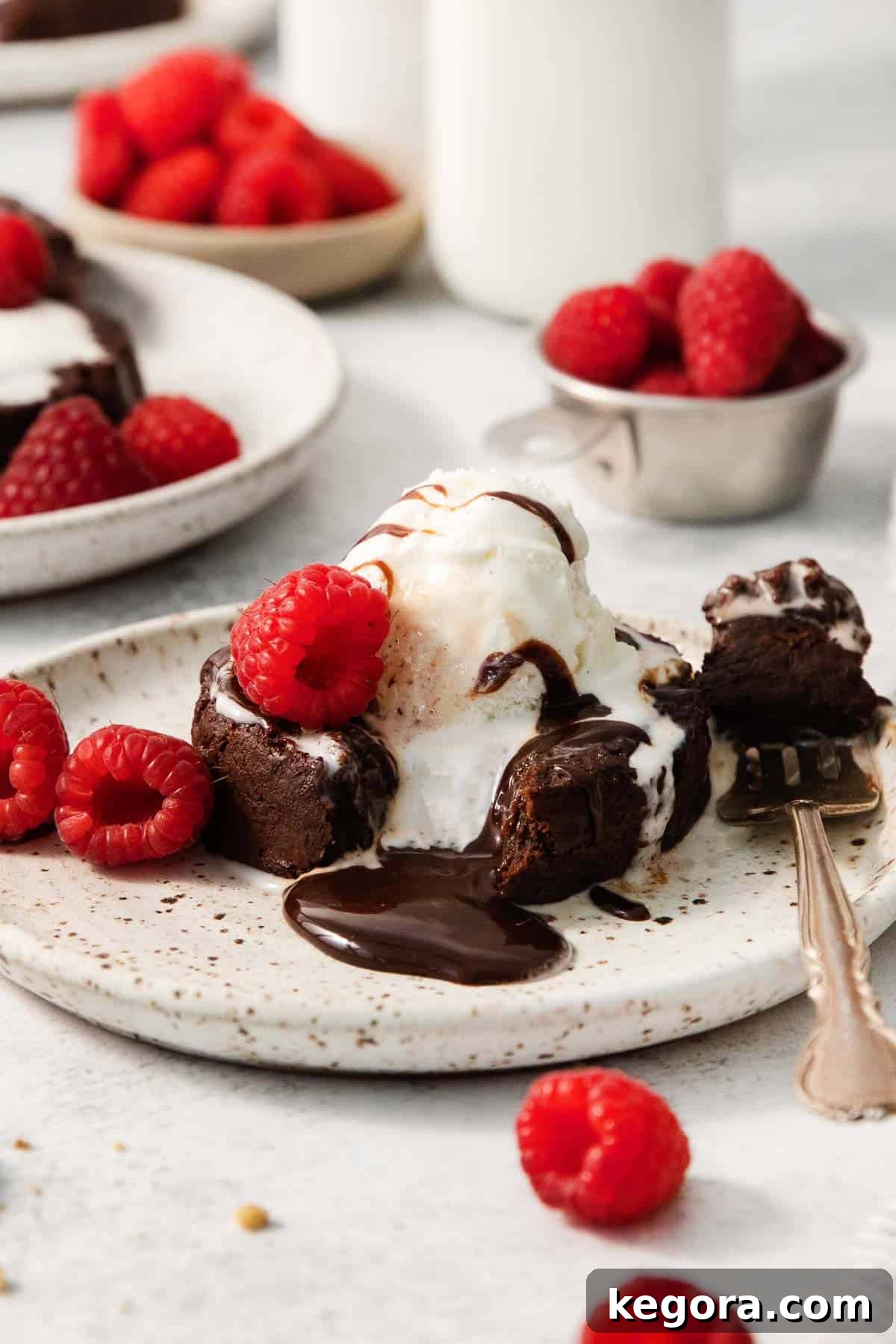 A close-up of a gluten-free chocolate lava cake on a plate, with a fork gently breaking into it to reveal the luscious molten center.