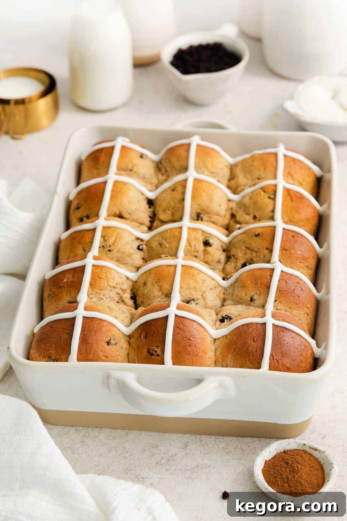 Fluffy Gluten-Free Hot Cross Buns 2 baked and iced hot cross buns in a baking pan