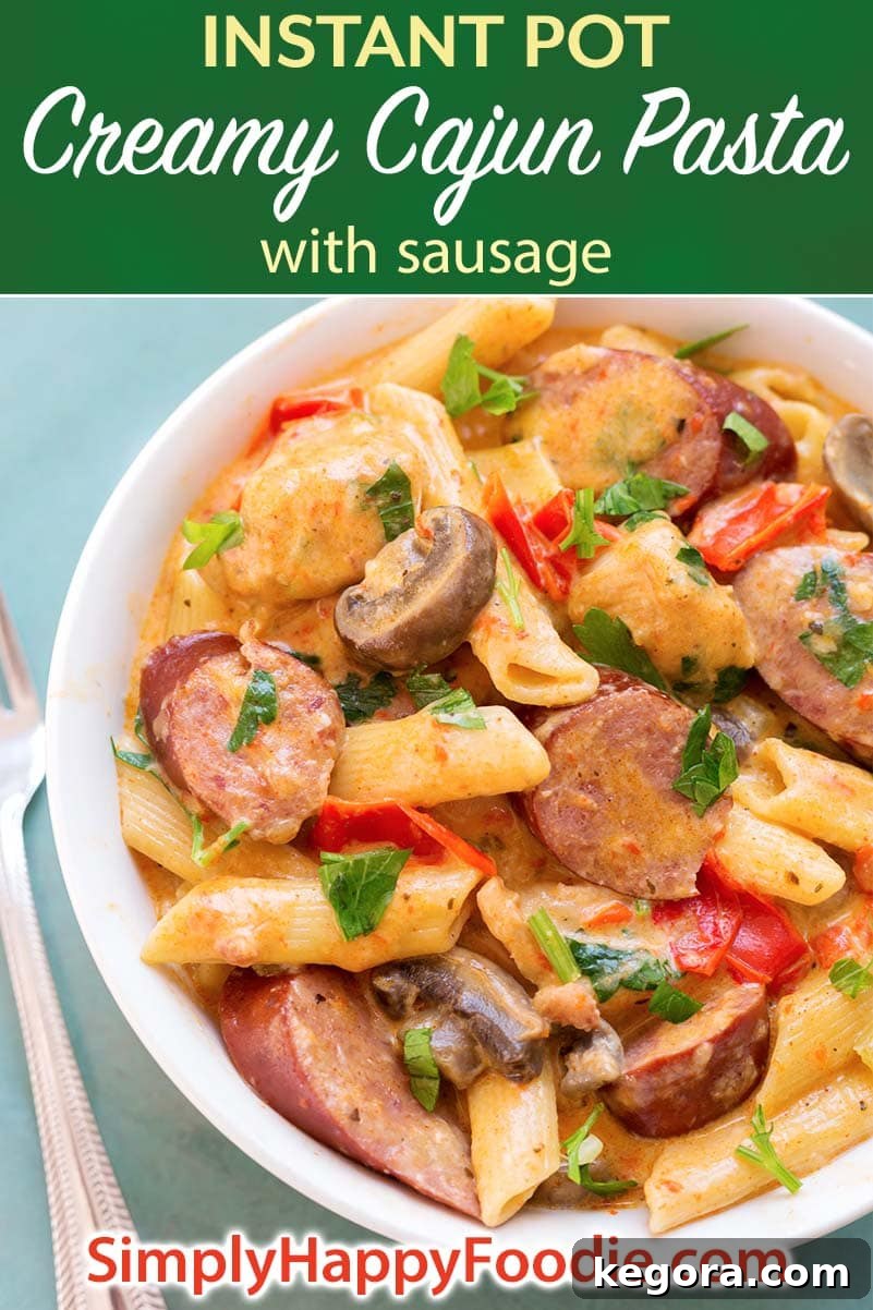 Instant Pot Creamy Cajun Pasta with Sausage is a super flavorful meal with penne pasta, smoky kielbasa, red bell pepper, and a creamy Cajun sauce. Pressure cooker Creamy Cajun Pasta with Sausage is a yummy one pot meal! Instant Pot recipes by simplyhappyfoodie.com #instantpotpasta #instantpotcajunpasta #pressurecookercajunpasta