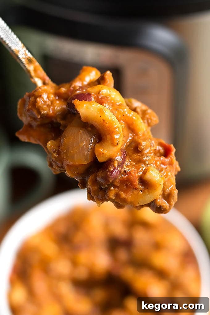 The Most Beloved Instant Pot Dishes of 2017 5 A spoonful of delicious Instant Pot Chili Mac, highlighting the rich chili and perfectly cooked macaroni, ready to be enjoyed.