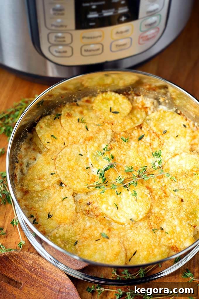 The Most Beloved Instant Pot Dishes of 2017 10 Instant Pot Cheesy Scalloped Potatoes in a metal springform pan, resting on a wooden board, with a pressure cooker blurred in the background, suggesting ease of preparation.