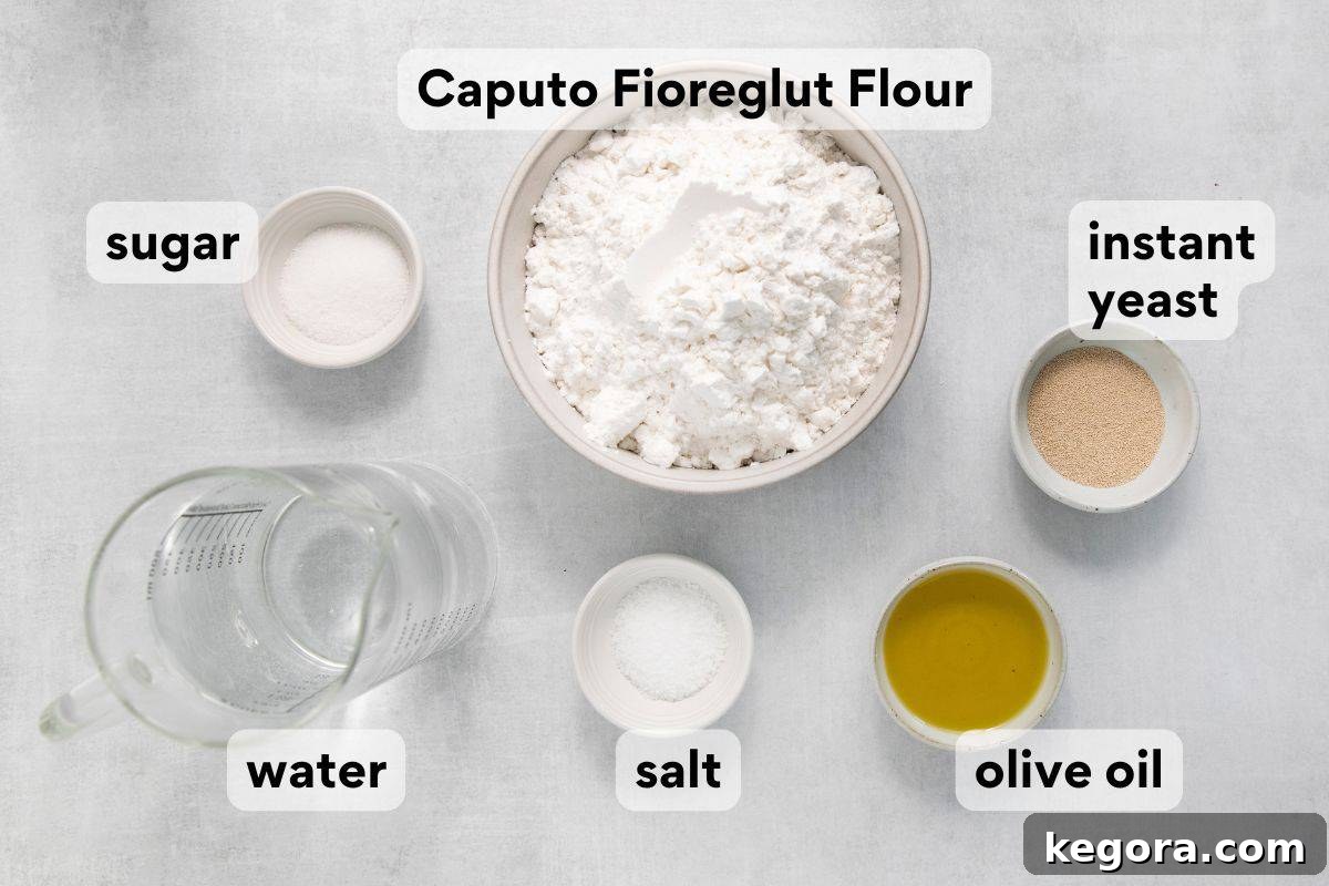 No Knead Overnight Gluten Free Focaccia with Caputo Flour 4 Focaccia ingredients laid out and measured, including flour, yeast, olive oil, and rosemary.