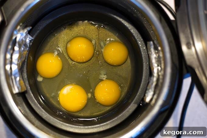 Five cracked eggs in small round pot for PIP cooking in pressure cooker