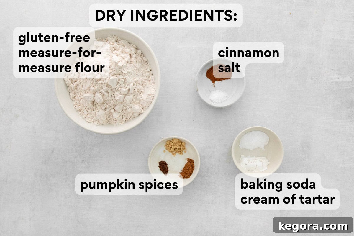 A bowl containing dry ingredients for gluten-free pumpkin snickerdoodles, including flour, spices, and leavening agents.