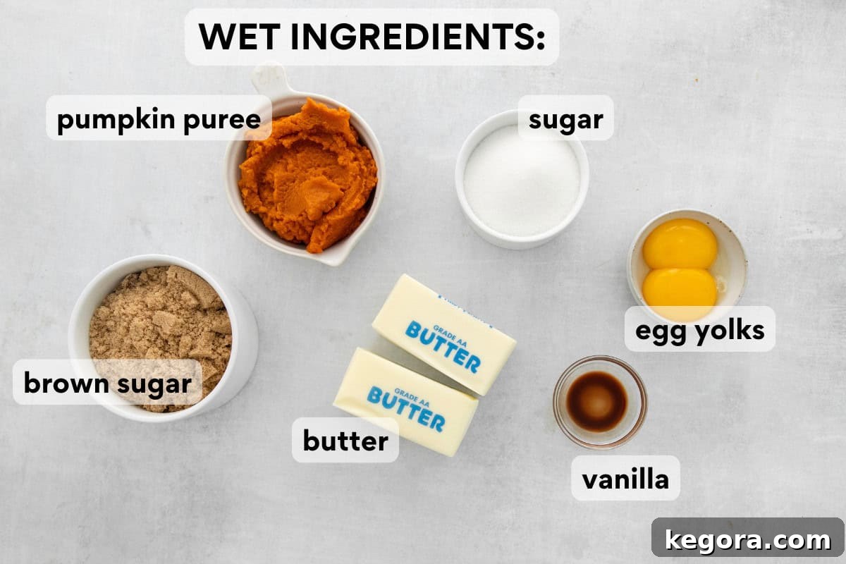 A collection of wet ingredients for gluten-free pumpkin snickerdoodles, including brown butter, pumpkin puree, and egg yolks.