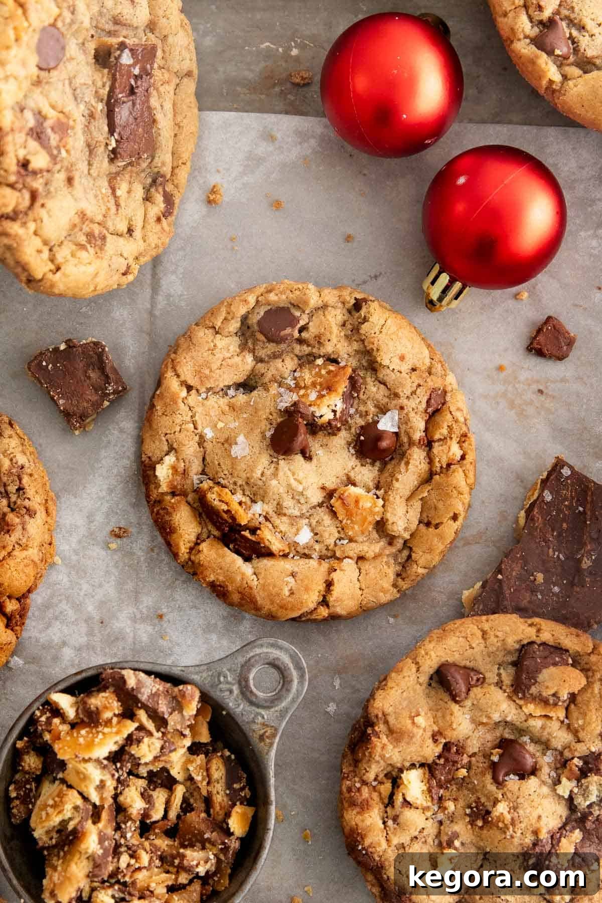 A festive holiday arrangement featuring beautifully baked Gluten-free Christmas crack cookies alongside chocolate, pinecones, and seasonal ornaments.
