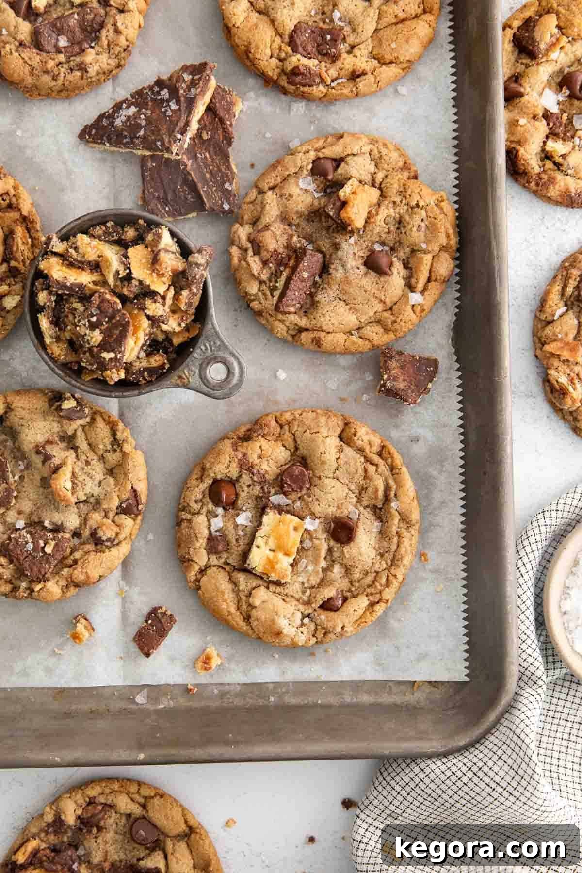 A baking sheet filled with warm, golden Gluten-free Christmas crack cookies, garnished with flaky sea salt.