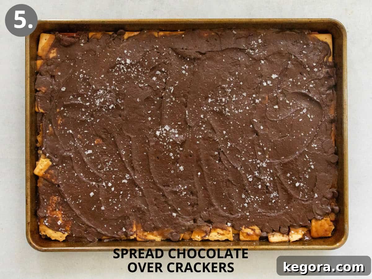 Smooth, melted chocolate perfectly spread over the gluten-free Christmas crack, topped with flaky sea salt.