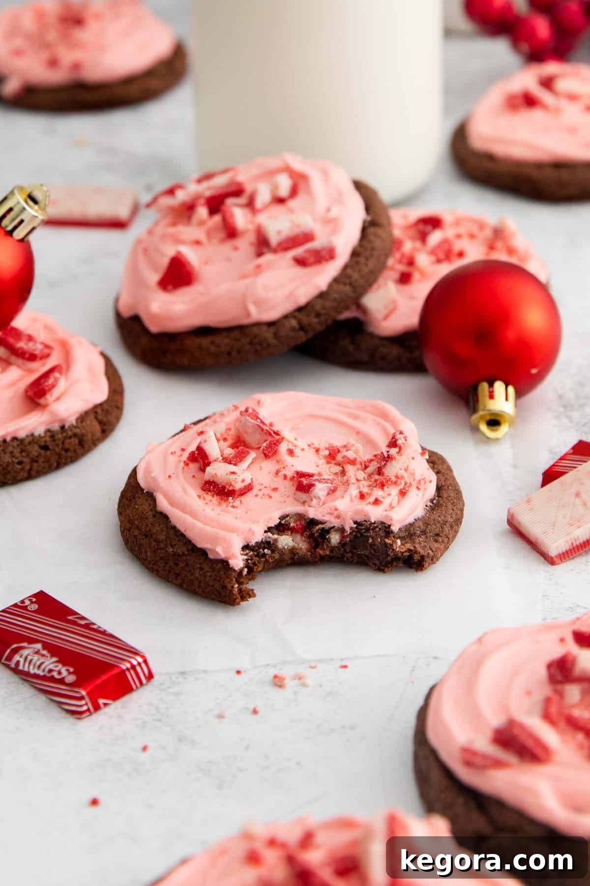 Heavenly Gluten-Free Peppermint Frosted Chocolate Cookies 10 Gluten-free peppermint frosted chocolate cookies on a countertop with ornaments and mints
