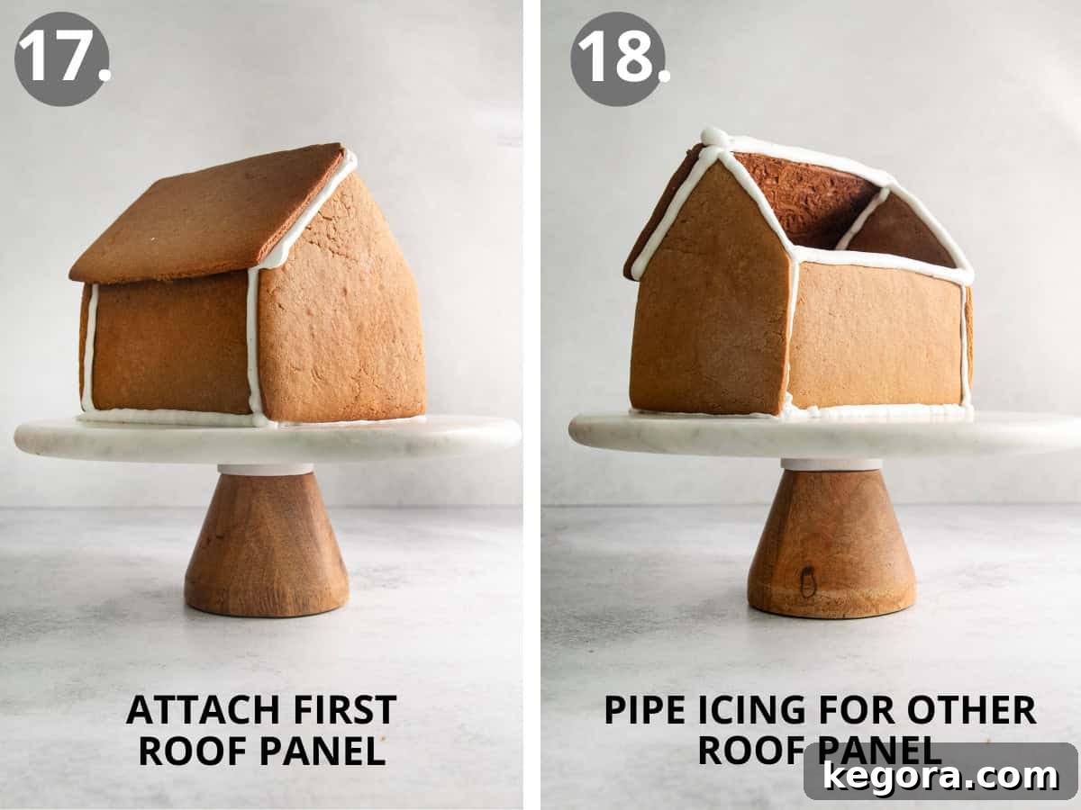One panel of the gluten-free gingerbread roof attached to the house, and icing being piped on the opposite side for the second panel