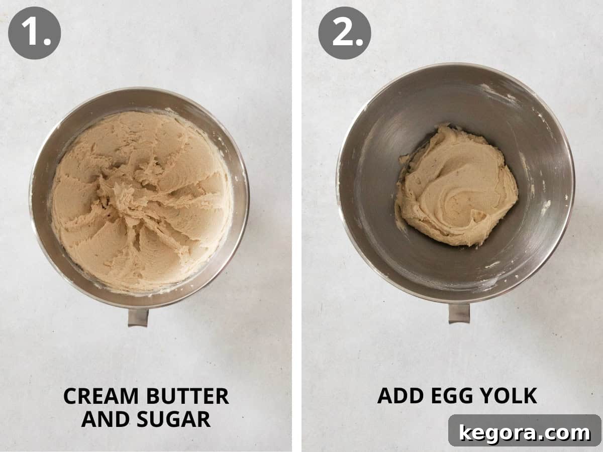 Butter and sugar being creamed, followed by an egg yolk being added to the mixture