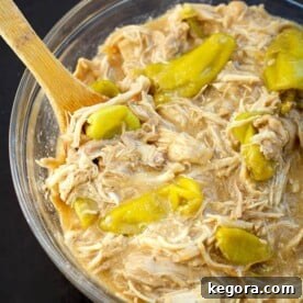 Mississippi Chicken in a glass bowl with wooden spoon