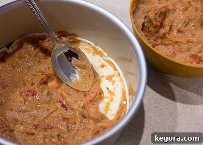 Effortless Instant Pot Taco Bake 4 Refried beans spread on a tortilla in a pan