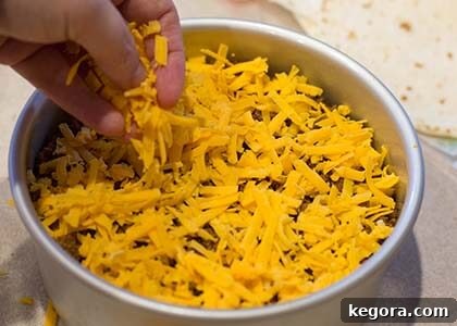 Effortless Instant Pot Taco Bake 6 Shredded cheese covering the meat layer